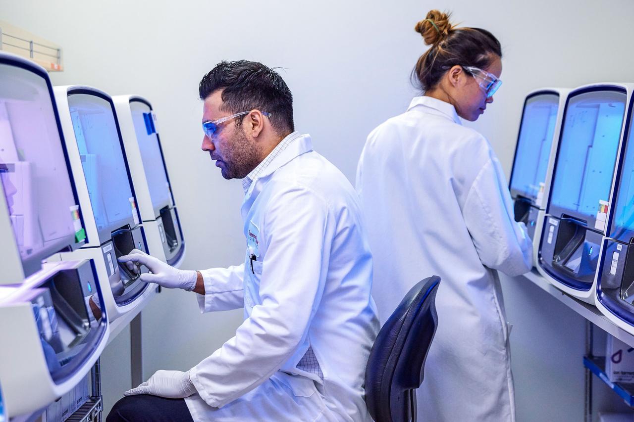 Scientists operating sequencing instruments